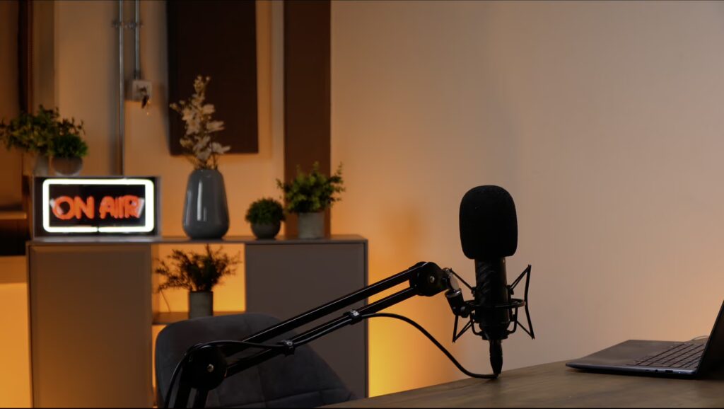 Picture of Outset Studio Shoreditch London, with a microphone, grey chair and table.